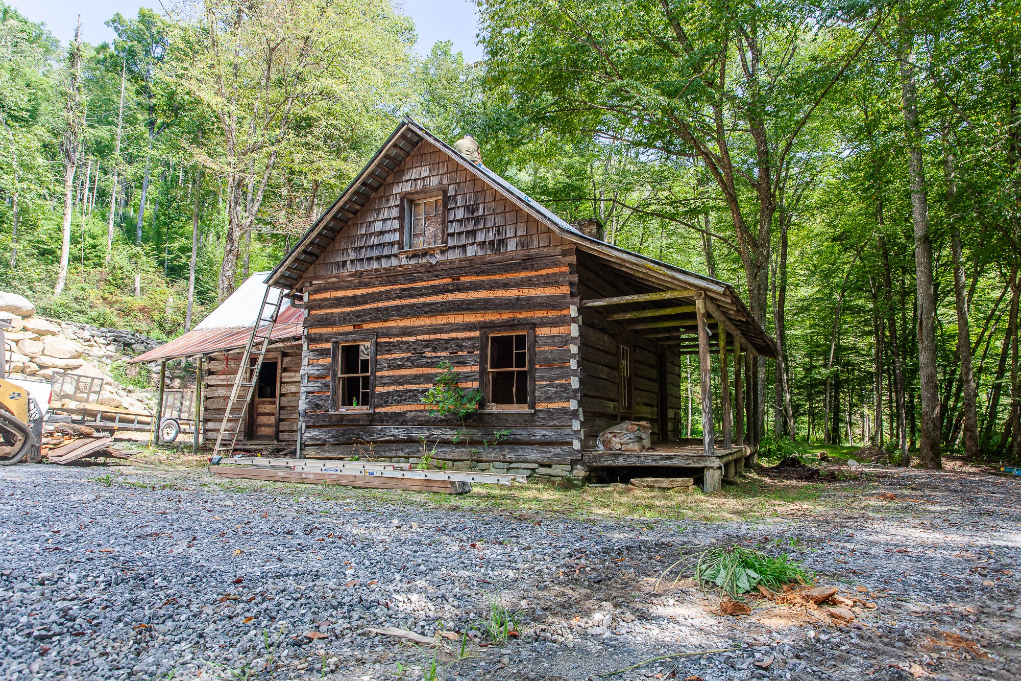 Delapidated mountain log cabin in the process of deconstruction