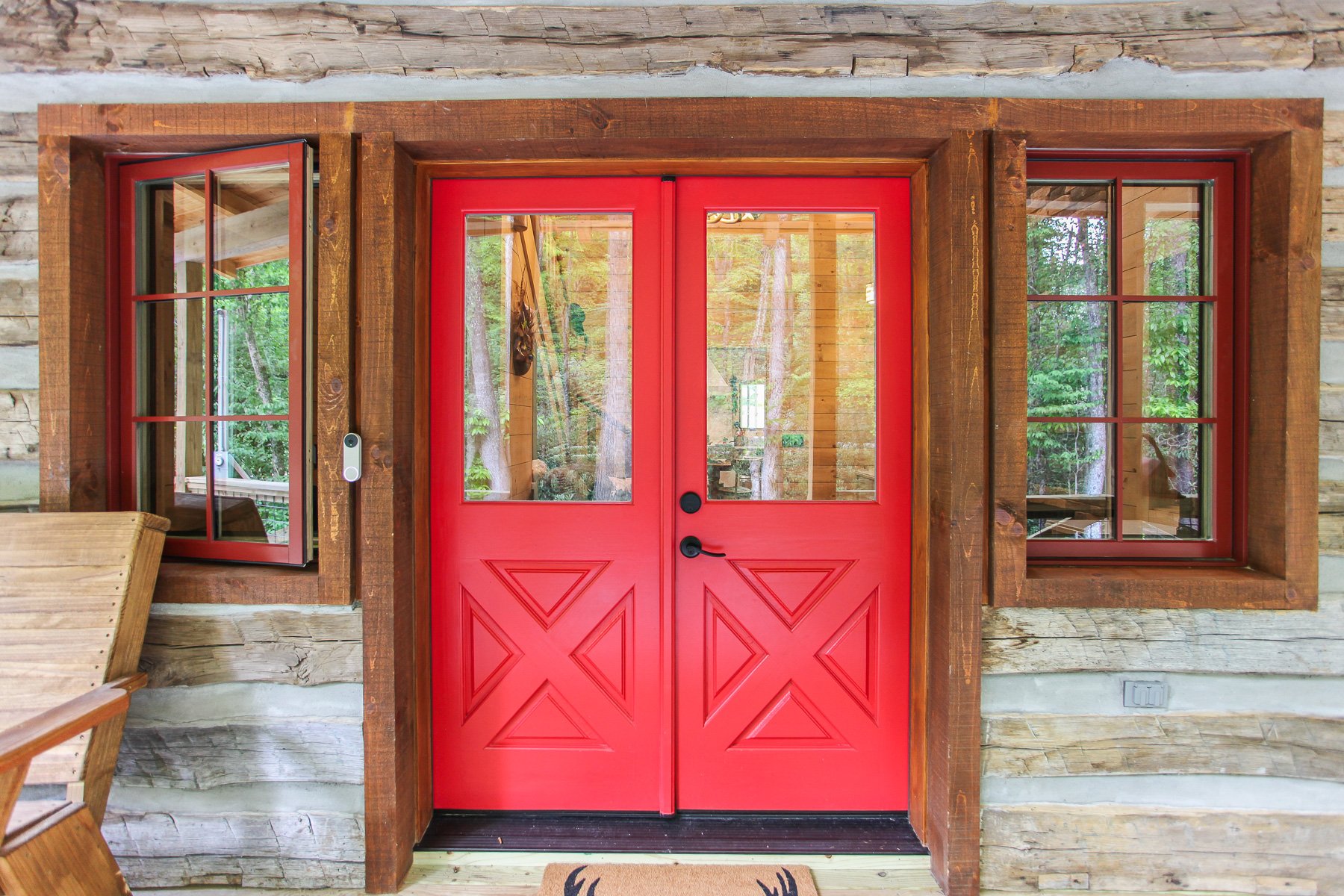 red front doors squared log home exterior